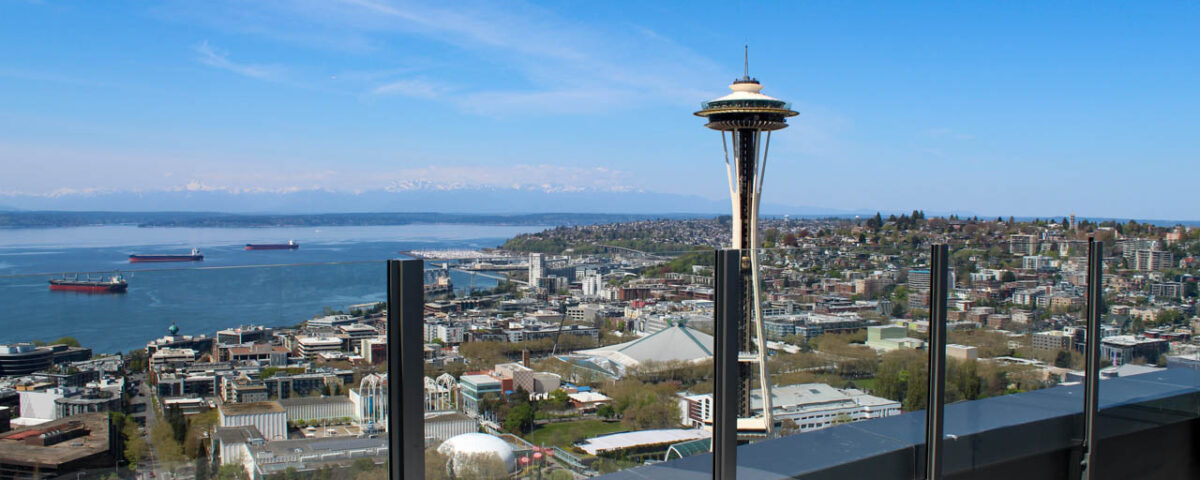 Glass railing on Spire Seattle's rooftop patio with a view of the Space Needle
