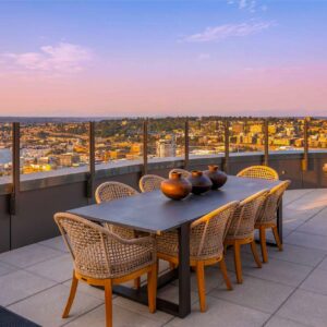 Glass railing on Spire Seattle's rooftop patio during the evening Golden Hour