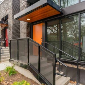 Metal railings with sun shade and porches on first level apartments