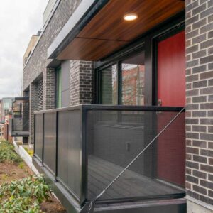 Metal railings with sun shade and balcony on first level apartments