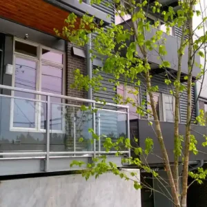 Sun shade with framed glass railing example and a peek of vertical sun shade accents