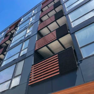 Custom mixed railings including wood and metal on an apartment complex's balconies